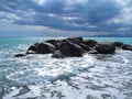 Sea Ã¢â¬â¹Ã¢â¬â¹coast with rocks after a storm, black clouds in the sky. Royalty Free Stock Photo